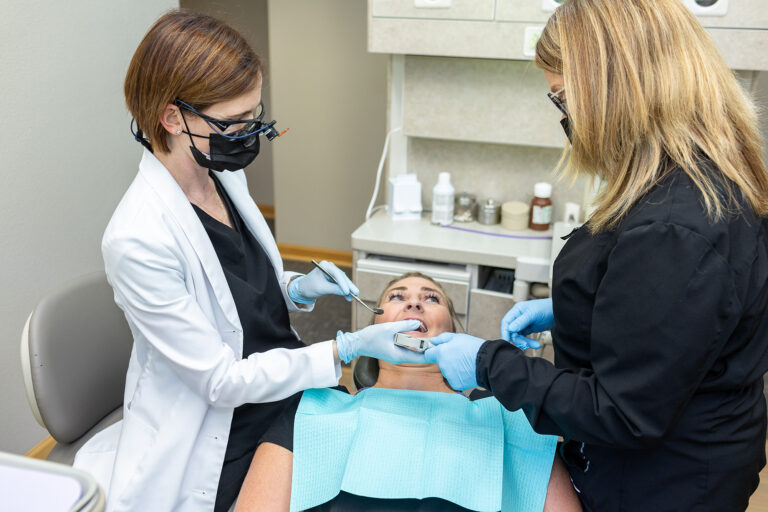 Dr. Matlock and a hygienist work together on a patient at Matlock Dental in Eugene, Oregon.