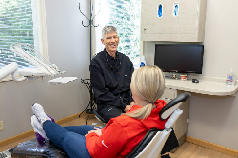 Dr. Stephenson laughing with a patient at Matlock Dental in Eugene, Oregon.